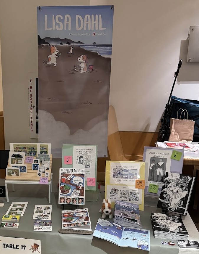 A picture of my convention table at 2026 Pride in Panels.