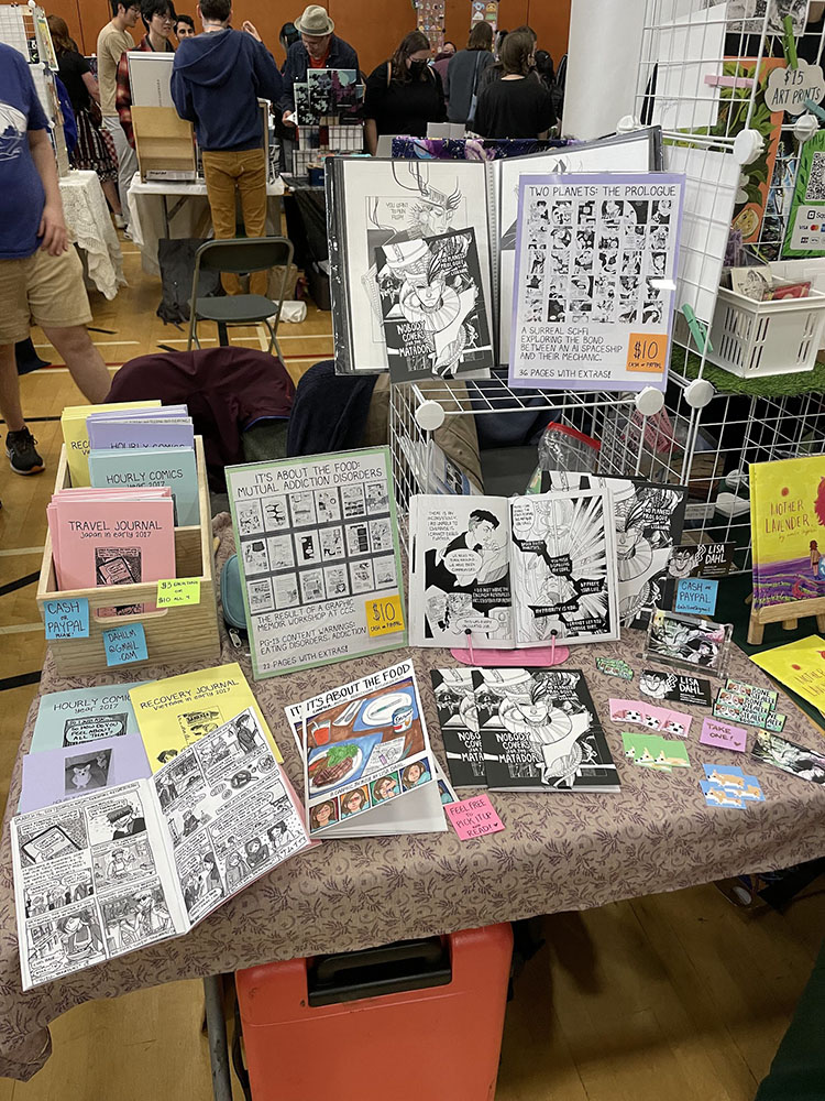 A picture of my convention table in 2023 VanCAF.